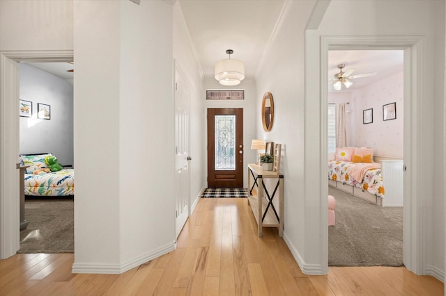 foyer with ceiling fan and light hardwood / wood-style floors