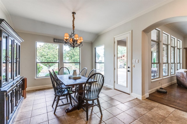 tiled dining room featuring crown molding, lofted ceiling, and a notable chandelier