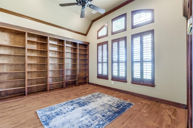 interior space featuring ceiling fan, vaulted ceiling, and light wood-type flooring