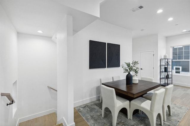 dining space with hardwood / wood-style flooring