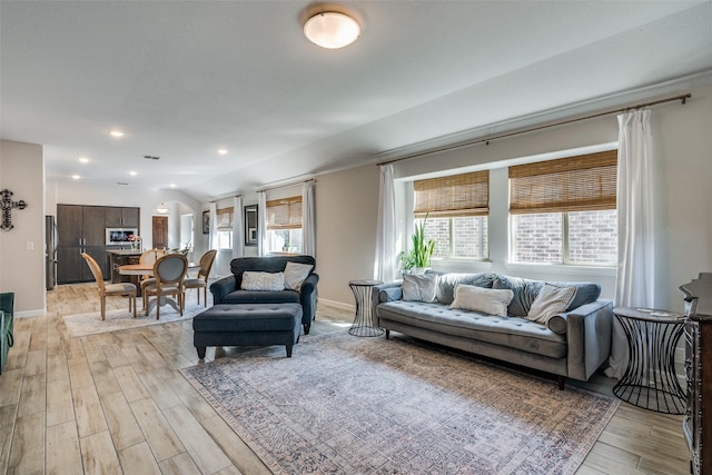 living room with vaulted ceiling and light hardwood / wood-style floors