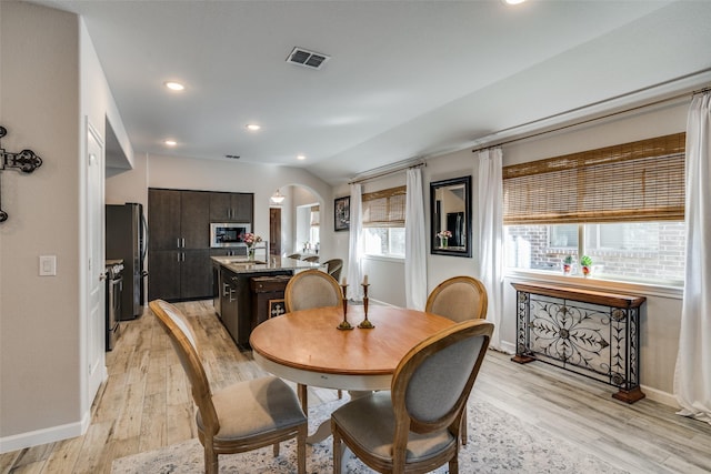 518 Whitney Ln, Lavon, TX 75166 - dining room with visible vents, baseboards, light wood-style flooring, and arched walkways