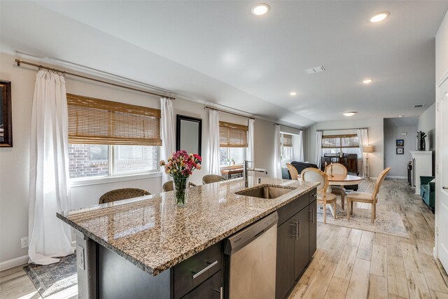 518 Whitney Ln, Lavon, TX 75166 - kitchen with a sink, a breakfast bar, stainless steel appliances, dark brown cabinets, and wall chimney exhaust hood