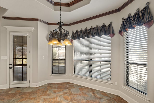 unfurnished dining area featuring a raised ceiling, ornamental molding, and a chandelier