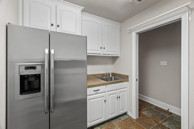 kitchen featuring sink, white cabinets, and stainless steel fridge with ice dispenser