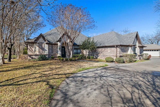 view of front of property with a garage and a front yard