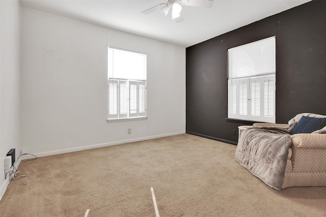 living area featuring ceiling fan and light colored carpet