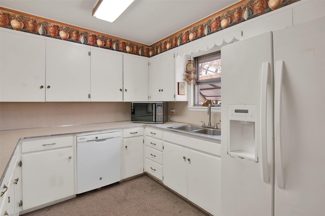 kitchen featuring white cabinetry, sink, and white appliances