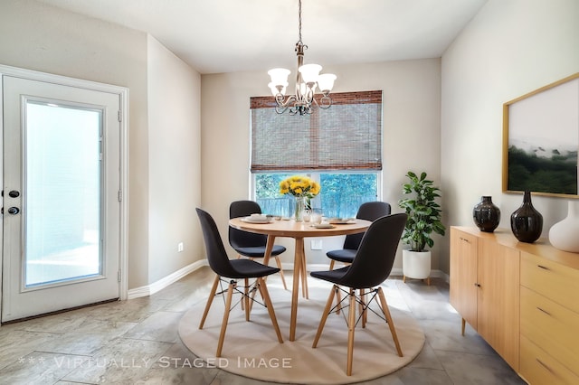 dining space with a chandelier and a healthy amount of sunlight