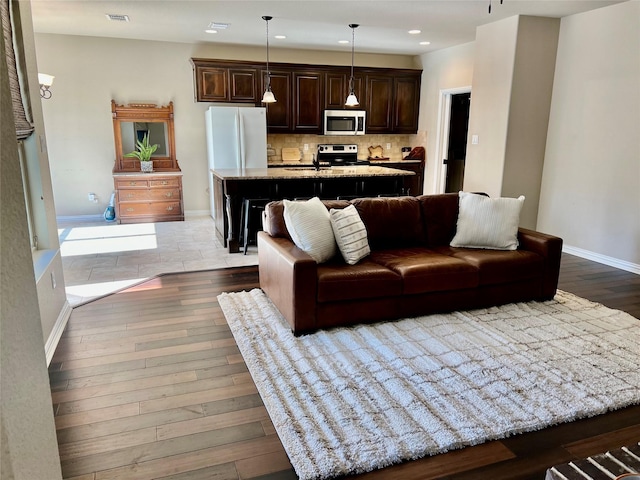 living room with sink and hardwood / wood-style floors