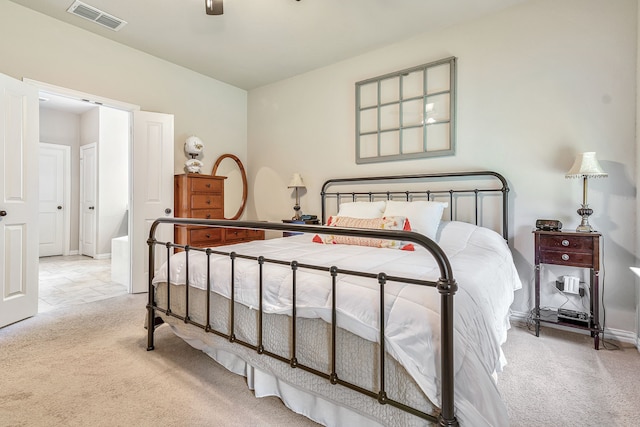 bedroom with ceiling fan and light colored carpet