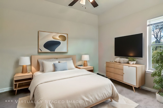 bedroom featuring ceiling fan, multiple windows, and carpet