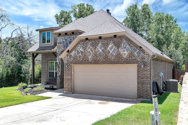 view of front of property featuring a front lawn, a garage, and cooling unit