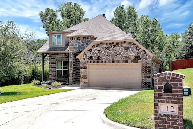 view of front of house with a front yard and a garage