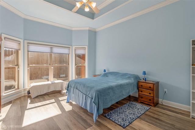 bedroom with ceiling fan, crown molding, and hardwood / wood-style flooring