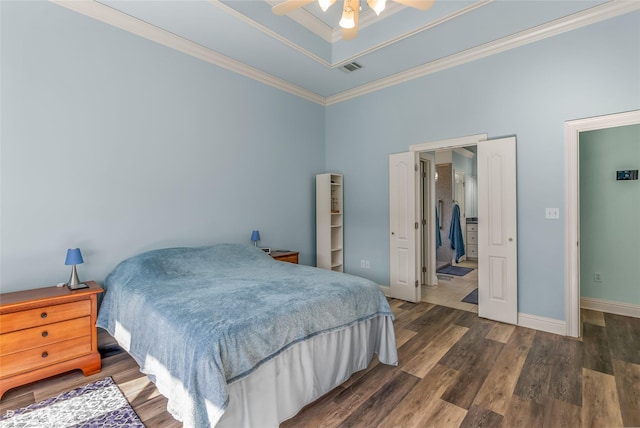 bedroom with ceiling fan, dark hardwood / wood-style floors, a towering ceiling, and ornamental molding