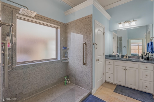 bathroom with a wealth of natural light, vanity, ornamental molding, and tile patterned flooring