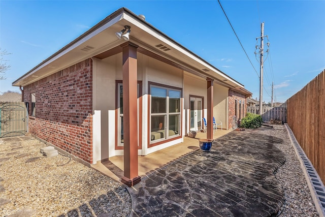 view of side of home featuring a patio area