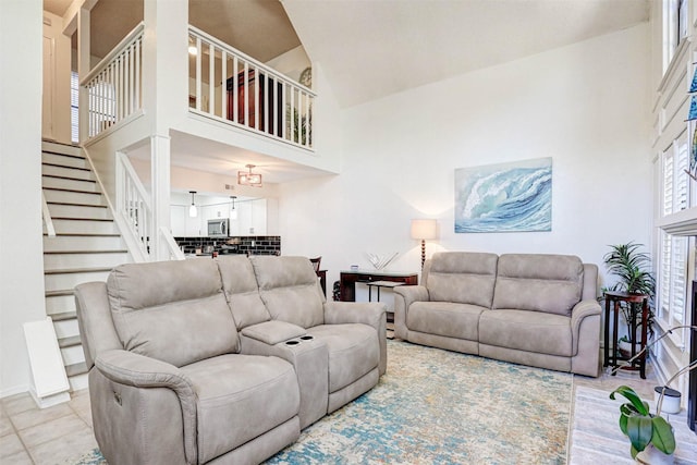 living room featuring high vaulted ceiling