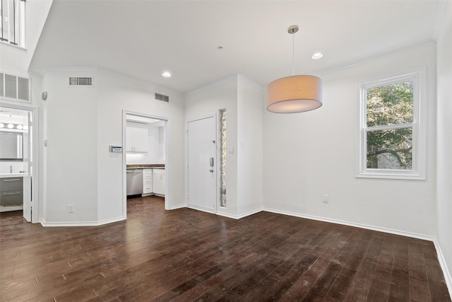 spare room featuring dark wood-type flooring and ornamental molding