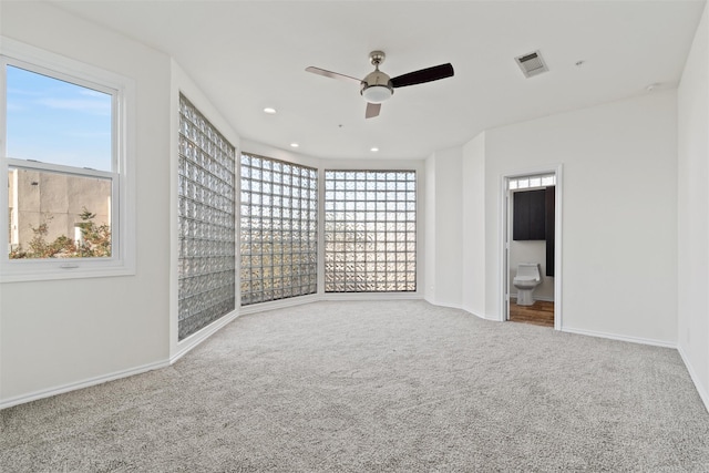 carpeted empty room featuring ceiling fan and a healthy amount of sunlight