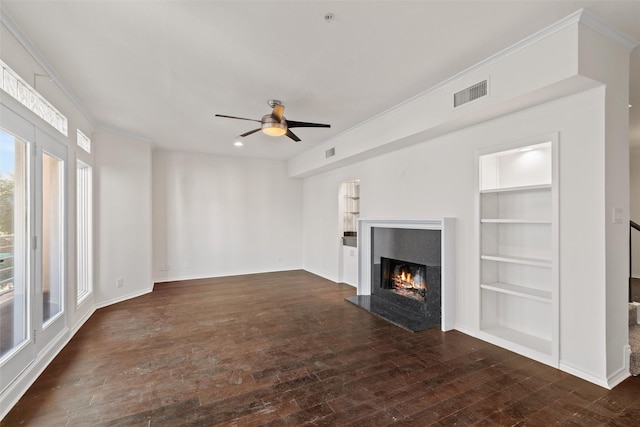 unfurnished living room with dark wood-type flooring, ceiling fan, and built in features