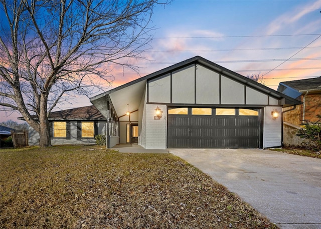 view of front facade with a garage and a lawn