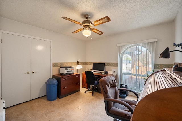 office with light tile patterned floors, a textured ceiling, and a ceiling fan