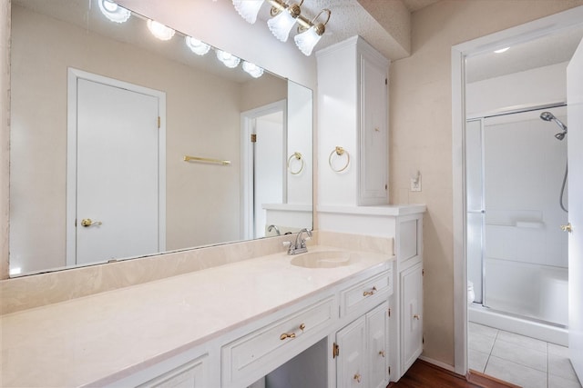 bathroom with a stall shower and vanity