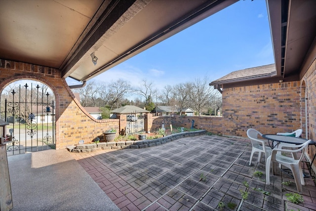 view of patio / terrace featuring fence and a gate