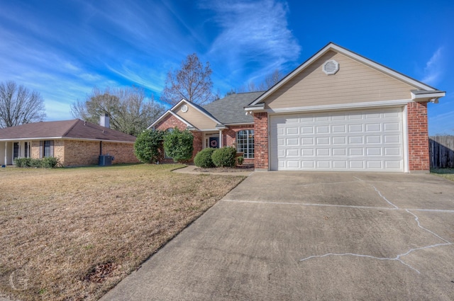 single story home featuring a garage and a front lawn