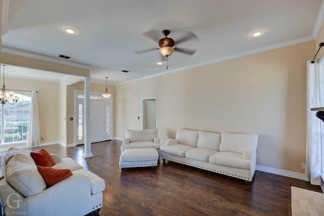 living room featuring dark hardwood / wood-style flooring, ceiling fan with notable chandelier, ornamental molding, and ornate columns