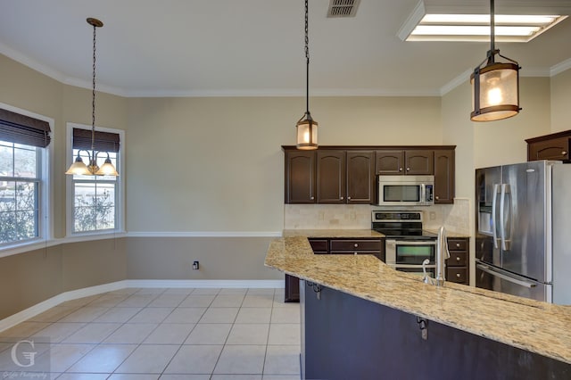 kitchen with decorative light fixtures, light stone countertops, dark brown cabinetry, and stainless steel appliances