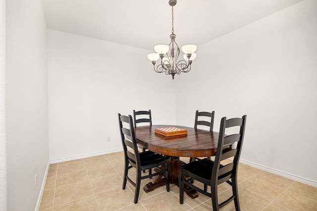 dining area featuring baseboards, a chandelier, and light tile patterned flooring