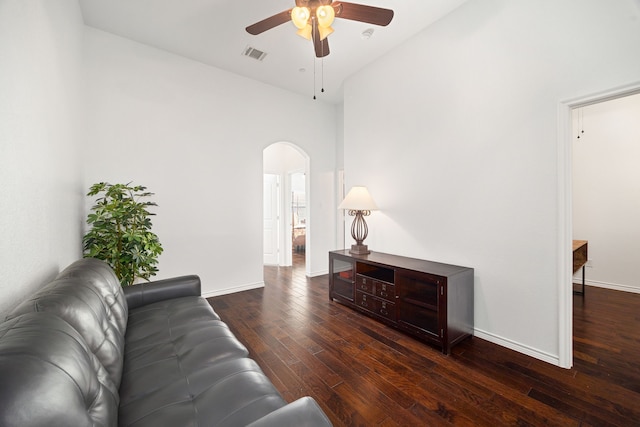 living area with visible vents, arched walkways, wood-type flooring, baseboards, and ceiling fan