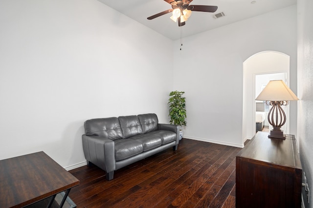 sitting room with visible vents, ceiling fan, baseboards, hardwood / wood-style flooring, and arched walkways