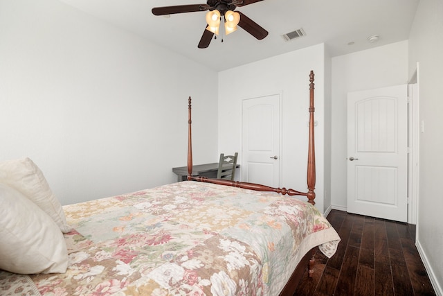 bedroom with ceiling fan, wood finished floors, visible vents, and baseboards