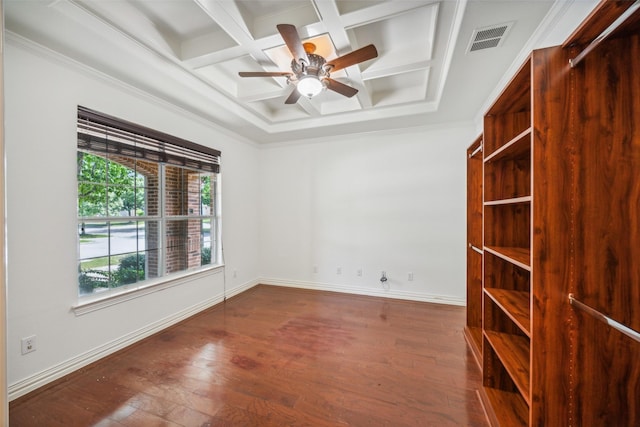 spare room with coffered ceiling, ceiling fan, dark wood-type flooring, crown molding, and beam ceiling