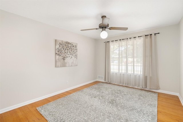 spare room featuring ceiling fan and hardwood / wood-style floors