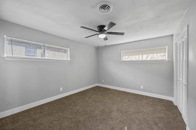 unfurnished bedroom with ceiling fan, carpet flooring, and a closet