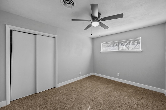 unfurnished bedroom with ceiling fan and carpet floors