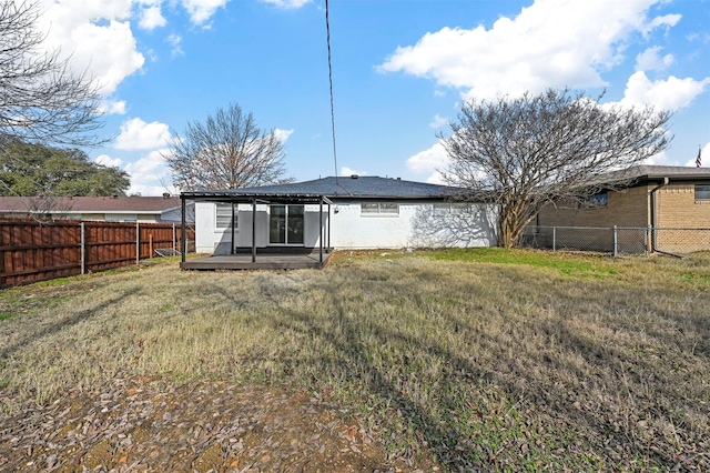 back of house with a yard and a patio