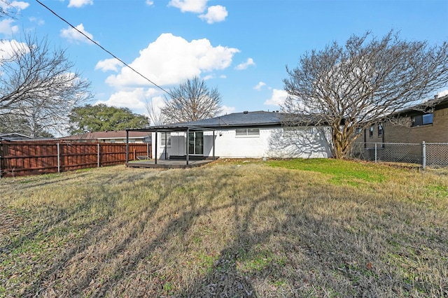 rear view of house featuring a patio and a yard