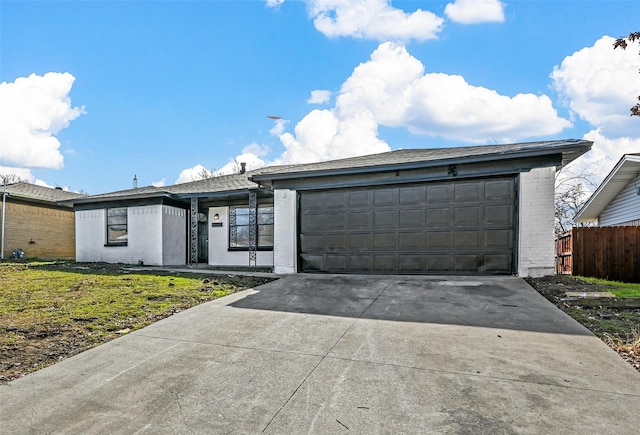 ranch-style home with a garage and a front lawn