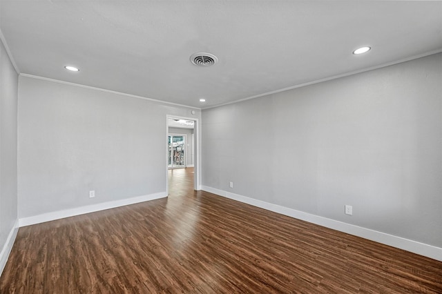 empty room with dark hardwood / wood-style flooring and ornamental molding