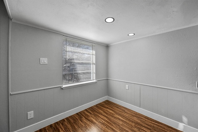 empty room featuring dark hardwood / wood-style flooring and ornamental molding