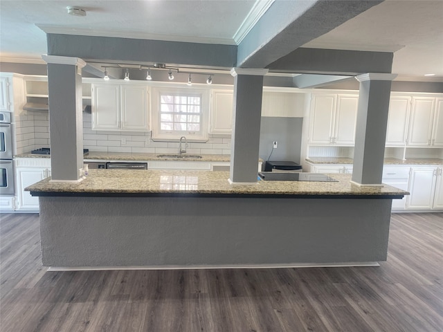 kitchen with dark hardwood / wood-style flooring, sink, white cabinets, and a center island