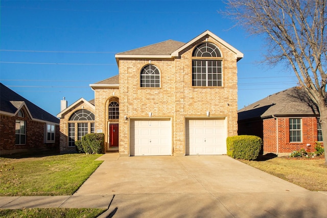 front facade featuring a front yard and a garage