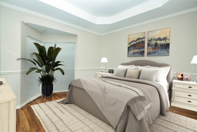 bedroom with a tray ceiling, dark hardwood / wood-style floors, and crown molding