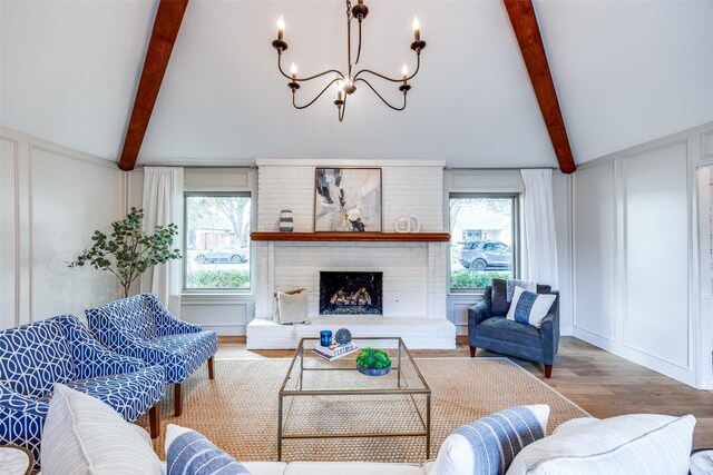 foyer entrance with a raised ceiling, a notable chandelier, and light hardwood / wood-style floors